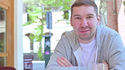 A glass of cold beer on a table in a restaurant. A man takes a large mug Video stock 132242385