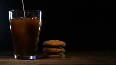 Glass cold brew coffee with ice and milk on black background Stock Footage 102721739