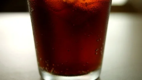 Glass of cold cola with ice cubes Stock Footage 114264341