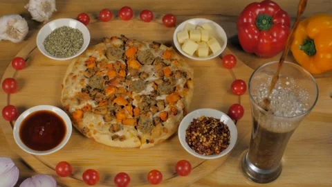 A glass of cold drink is being served with delicious chicken sausage pizza Stock Footage 153130665