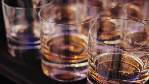 Glass with a cold drink .Glasses with drinks reflect the lights of sun. Stock Footage 195211652