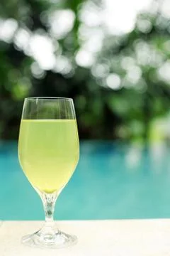 A glass of cold drink by the poolside Stock Photos