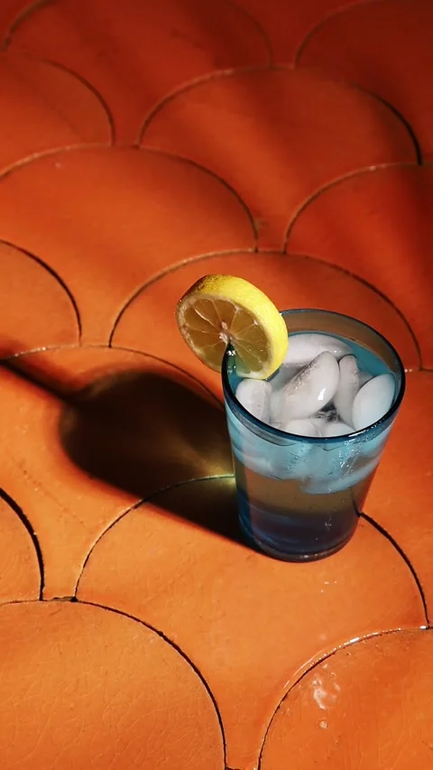 Glass of cold lemonade with flickering shadows 스톡 동영상 249293930