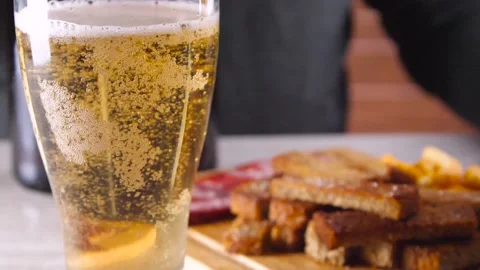 Glass of cold light beer on the background of the snacks Stock Footage 88582740