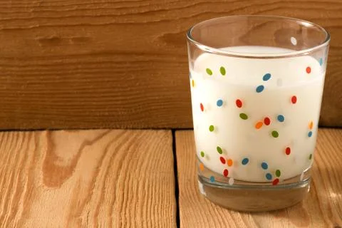 A glass of cold milk stands Stock Photos