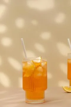 A glass of cold tea, ice cubes, lemon slices. Cooling summer drinks. Stock-Fotos