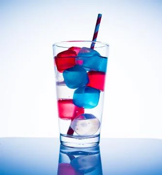 Glass with colored cubes Stock Photos