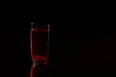 Glass of compote on a dark background Stock Photos