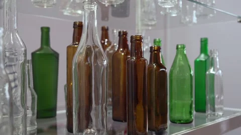 Glass container for drinks, clear green brown glass juice beer wine bottle Stock Footage 317129665