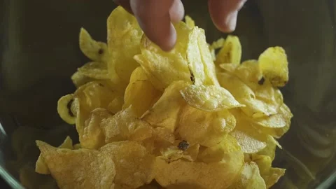 Glass containers of chips take one. on a black background. the view from the top Stock Footage 130523754