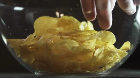 Glass containers of chips take one. on a black background 스톡 동영상 130523885