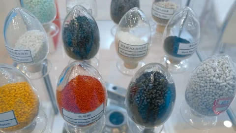 In glass containers, samples of plastic granules of different colors Stock Footage 187789918
