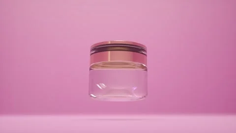Glass cosmetic empty jar isolated on pink background. Bottle rotates slowly in Stock Footage 276444890