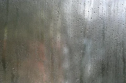 Glass with countless water droplets forms atmospheric backdrop. 스톡 사진