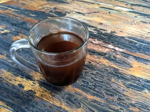 Glass cup of black coffee on rustic wooden table Stock Photos