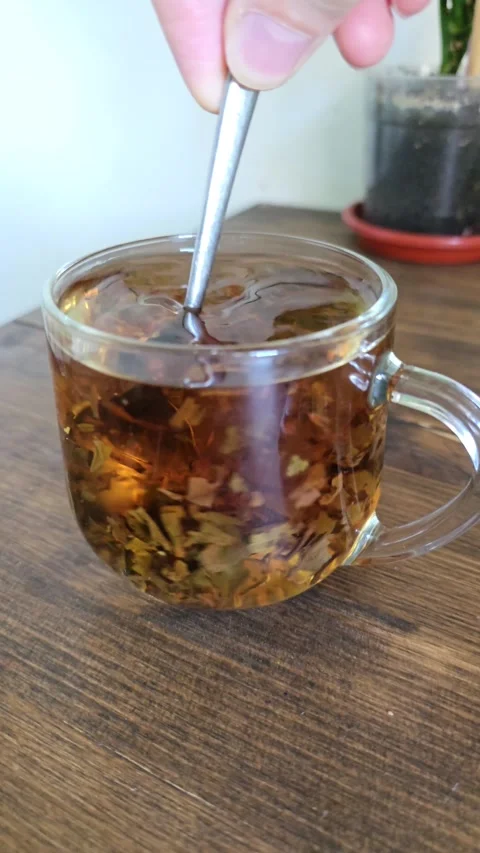 Glass Cup Black Leaf Tea Close Up Stirred Stainless Spoon Super Slow Motion Tea Stock Footage 321808729