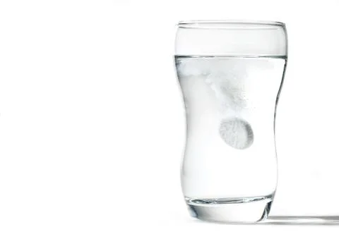 Glass cup with effervescent tablet Stock Photos