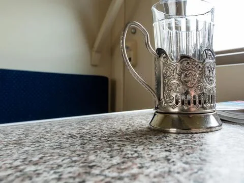 Glass in cup holder close up on table in train Stock Photos