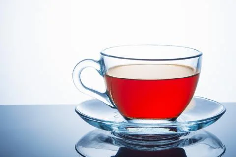 Glass cup of hot aromatic tea on white background. Close up. Stock Photos