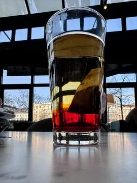 Glass cup with hot tea on a table on a varanda Stock Photos