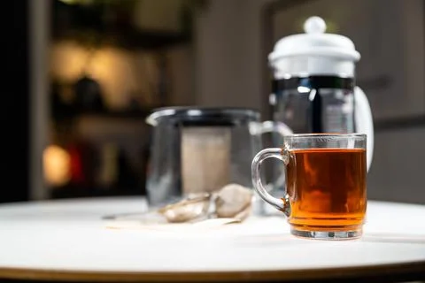 Glass cup mug of fresh warm tasty Ceylon black tea with french press, teapot, Stock Photos
