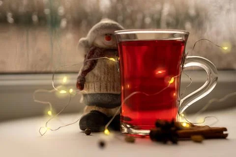 A glass cup of a red warming drink (tea, mulled wine, punch). ingredients Stock-Fotos