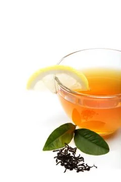 Glass cup of tea with a slice of lemon on a white background. Stock Photos