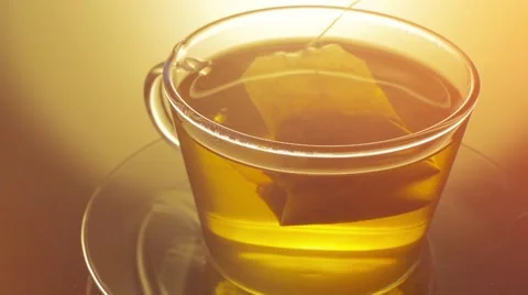 Glass cup of tea with teabag close up Stock Footage 57460162