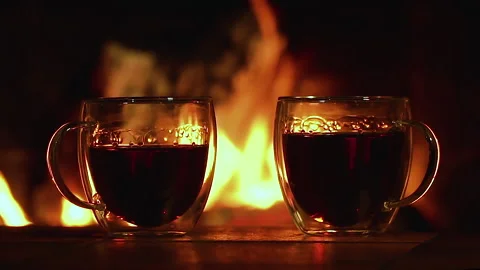 Glass cups with tea on the background of the fireplace Stock Footage 147451938