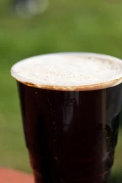 Glass of dark beer on the table Stock Photos