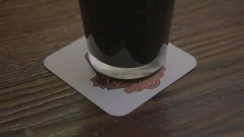 Glass of Dark Beverage Set on Coaster in Beijing Bar Interior, Close Up Table Stock Footage 345756768