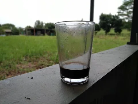 A glass of dark liquid Foto stock