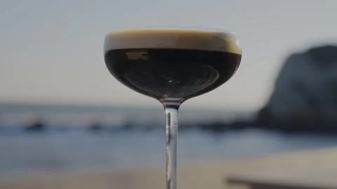 A glass of dark liquid is sitting on a stem Stock Footage 306575926