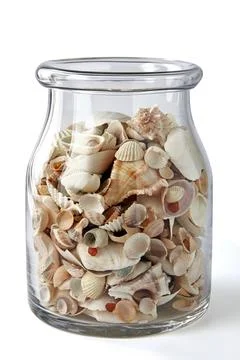 Glass decorative jar with different shells and pebbles isolated on white ba.. Stock Photos