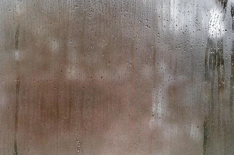 Glass with dense condensation forms abstract backdrop featuring wet texture and 写真素材