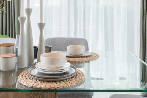 Glass dining table with table set in modern dining r Stock Photos