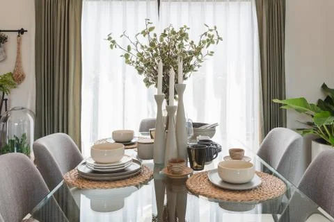 Glass dining table with table set in modern dining r Stock Photos