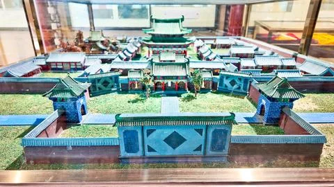 Glass display case presents a model of a traditional Chinese temple complex Stock Photos