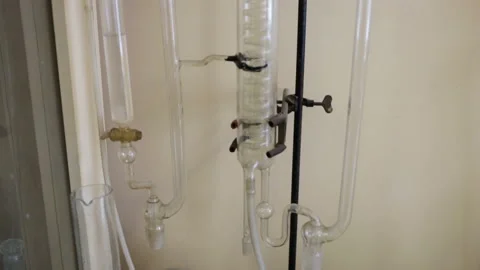 Glass distiller is on the table at the wall. The movement of the camera from the Stock Footage 85705777