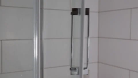 The glass door to the shower cabin opens, bathroom, transparent screen, close-up Stock Footage 164602427