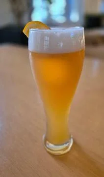 Glass of draft beer with a slice of orange Stock Photos