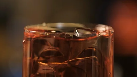In a glass with a drink of cola or juice the tubule falls beautifully. Stock Footage 106937482