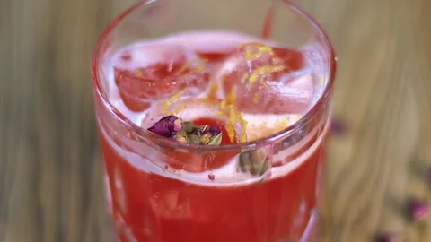 A glass with a drink standing on the table Stock Footage 136815889