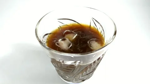 In a glass of drink throwing ice cubes Stock-Footage 69024361