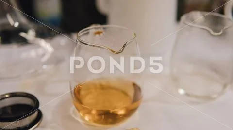 Glass dripper with brewed tea close-up. Tea tasting with a dripper and kettle Stock Photos