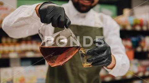 Glass dripper with brewed tea close-up. Tea tasting with a dripper and kettle Stock Photos
