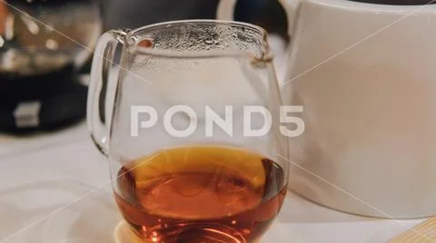 Glass dripper with brewed tea close-up. Tea tasting with a dripper and kettle Stock Photos