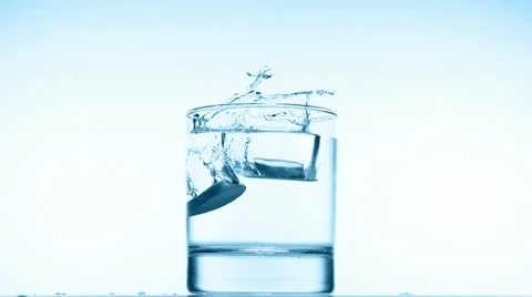 Glass with efervescent tablet in water, slow motion Stock Footage 20608308