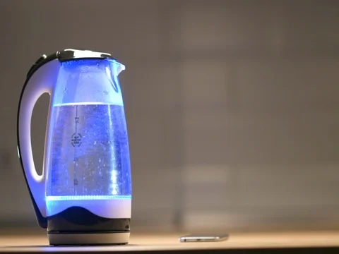 Glass electric kettle with lights boils Stock Footage 83236524