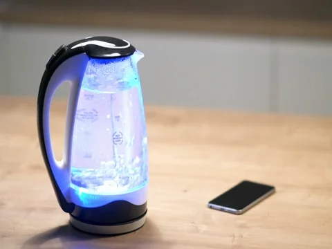 Glass electric kettle with lights boils Stock Footage 83236782